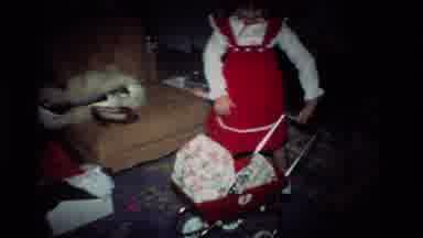 California USA (1984): A Little Girl Playing With Baby Cart And Cat Climbing