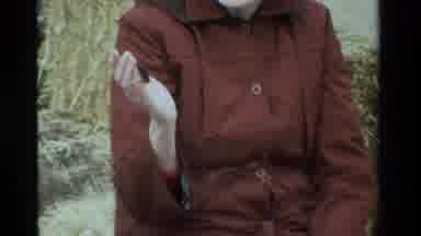 California USA (1984): Woman In A Red Coat With A Brown Fuzzy Caterpillar On Her