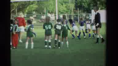 California USA (1984): Little Girls In A Huddle With Their Green Soccer Jerseys On