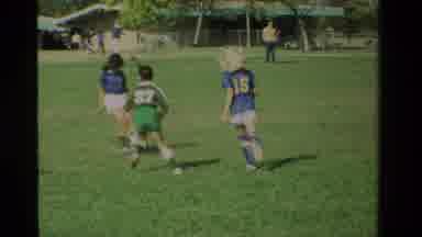 California USA (1984): Elementary-Aged Children Are Playing Soccer On Teams On A