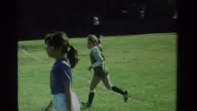 California USA (1984): Girls In Green And Purple Jersey Playing Soccer Outdoors On