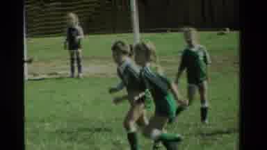 California USA (1984): Group Of Children Playing Soccer In Green Uniforms Girls