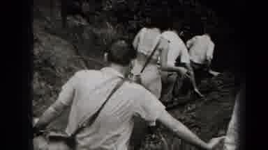 New York USA-1938: Men Hiking Up a Rocky Hillside
