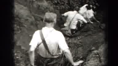 New York USA (1938): People Carrying Bags Carefully Going Down A Steep Hill In A