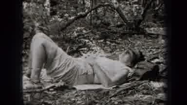 New York USA (1938): One Person Laying Down Two Other People Using Fire To Heat