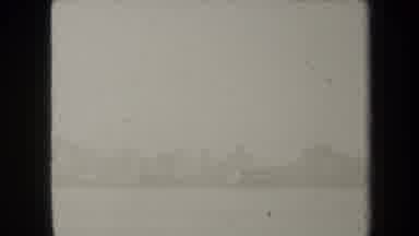 New York USA (1938): Three Adults On A Boat In Enclosed Area On An Overcast Day