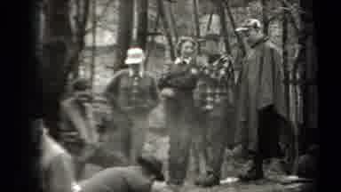 NEW YORK USA-1938: People Standing Around While A Man Fans The Smoke Of A Fire