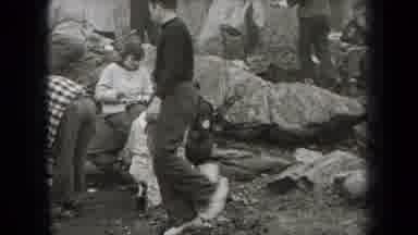 New York USA (1938): Group Of People Gathers Around A Set Of Pots And Cooks