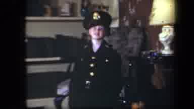 New York USA (1939): Young Boy Laughing Trying On His Father's Military Uniform