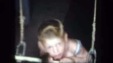 New York USA (1939): A Boy With No Shirts And Shorts On Swinging Face First On A