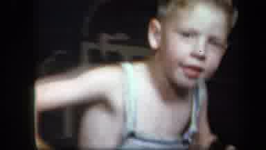New York USA (1939): A Blond Boy In Grey Top Playing In A Slide And Swing At Night