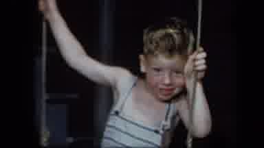 New York USA (1939): Small Boy On Old School Swing With Blurred Vintage Camera