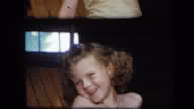 New York USA (1939): Seemingly Naked Little Girl With Curly Hair Smiles Adoringly