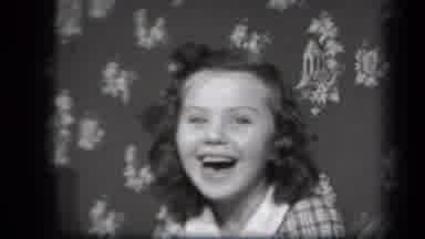 New York USA (1939): Boy Smiling In Front Of A Flowered Print Background Switches