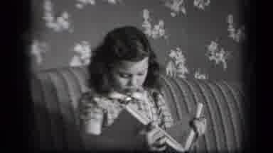 New York USA (1939): Girl Sitting On Couch Reading A Book Out Loud Boy Comes To