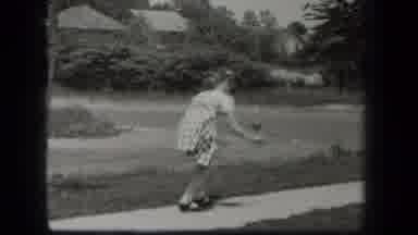 New York USA (1939): Girl Bounces Ball On Sidewalk Near Road In Dress In Black And