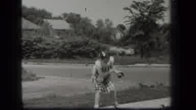 New York USA (1939): A Girl Is Playing Ball At Front Of House In Afternoon