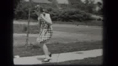 New York USA (1939): Young Girl Riding Her Bike And Playing With A Ball Out On The