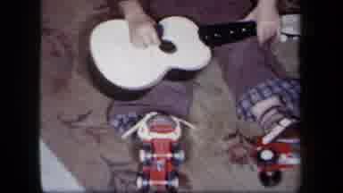 New York USA (1958): Young Boy Opens A Child's Guitar On Christmas Morning And Is