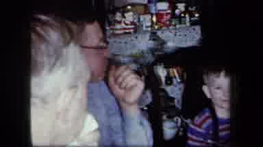 New York USA (1958): A Family Gathered Around A Table Imitating A Little Boy While