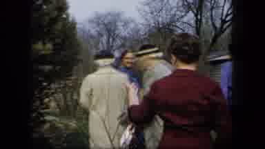 New York USA (1958): A Group Of People Walking In A Garden And Chatting