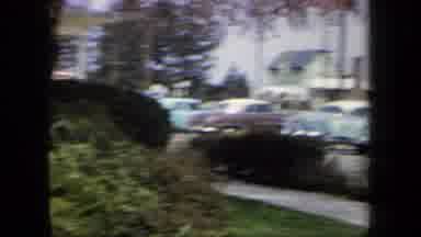 New York USA (1958): Two Ladies Waving From A Parking Lot With Old Cars