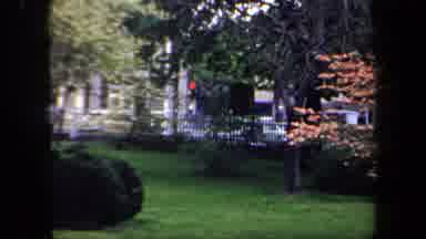 New York USA (1958): Truck Driving Down A Street Seen Through A Park And A Man