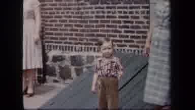 New York USA (1958): Young Boy Standing Between Two Women Before Zooming Into