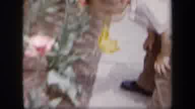 New York USA (1958): Child In Formalwear Smelling A Flower And Running Across