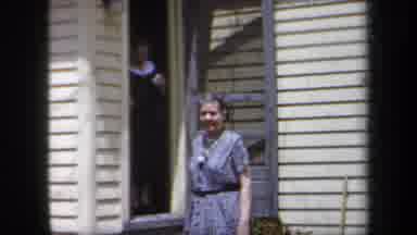 New York USA (1958): Two Older Woman Walking Out Of An Older House With Cream