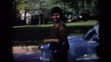 New York USA (1958): A Man And Woman Walking Through The Front Yard With A Blue
