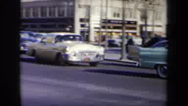 New York USA (1959): Cars Driving Down A Busy Street In A Central City Location