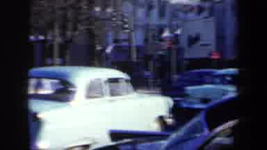 New York USA (1959): Cars Old Model People On Sidewalk Traffic Moving Face