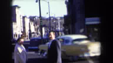 New York USA (1959): Two People Talking On A Street Corner And A Small Child Runs