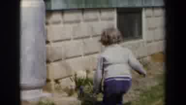 New York USA (1959): A Young Child In A Sweater Playing Next To A Building On