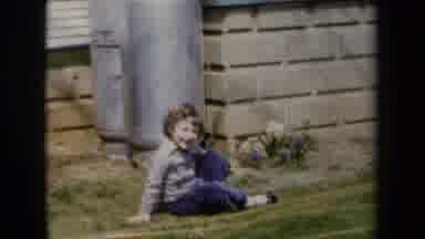 New York USA (1959): Little Boy Sitting On Grass In Yard Smiling And Walking In
