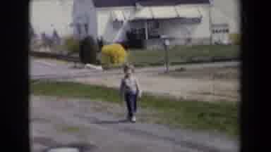 New York USA (1959): A Child Is Walking In Their Neighborhood After Leaving Their
