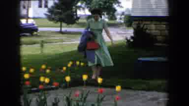 New York USA (1959): Woman Admiring Her Beautiful Flowers Outside Of Her Home