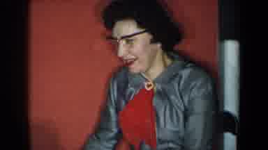 New York USA-1959: Woman in Gray Dress and Red Scarf Smiling