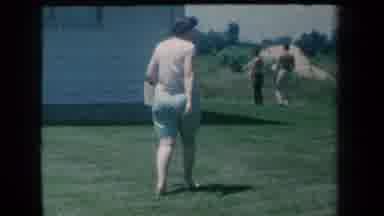 New York USA (1959): Woman Walking Outside Through A Yard Away From The Camera But