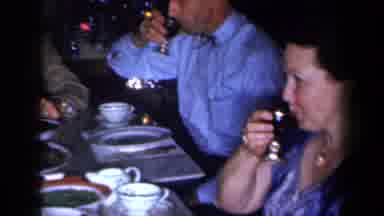 New York USA (1959): A Group Of People Passing Wine Around A Table Having Fun And
