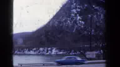 New York USA (1959): A View Of People Driving On The Street Near Mountain Peaks