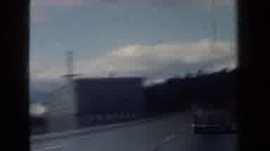 New York USA (1959): Older Cars Driving Down A Road Looking At The Scenery Around