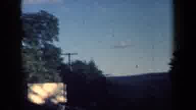 New York USA (1959): Driving Down A Country Road Passed Old Power Lines Against