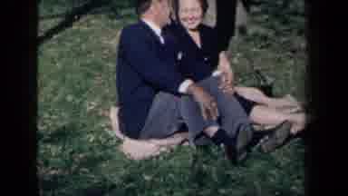 New York USA (1959): An Old Couple Smiling And Sitting On The Grass On A Sunny Day