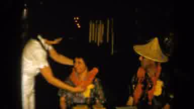 California USA-1961: Sitting Woman Receiving Floral Necklace From Another Woman