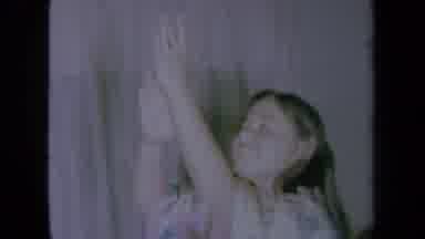 California USA (1961): A Women Dancing Waving Her Arms In The Air Smiling Looking