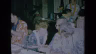 California USA (1961): Adult Men And Women Eating Food At A Hawaiian Luau And