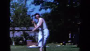 California USA (1961): Woman Runs And Throws Broom While Group Of Spectators Stand