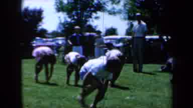 California USA (1961): Kids Kneel Racing Across The Grass To The Finish Line
